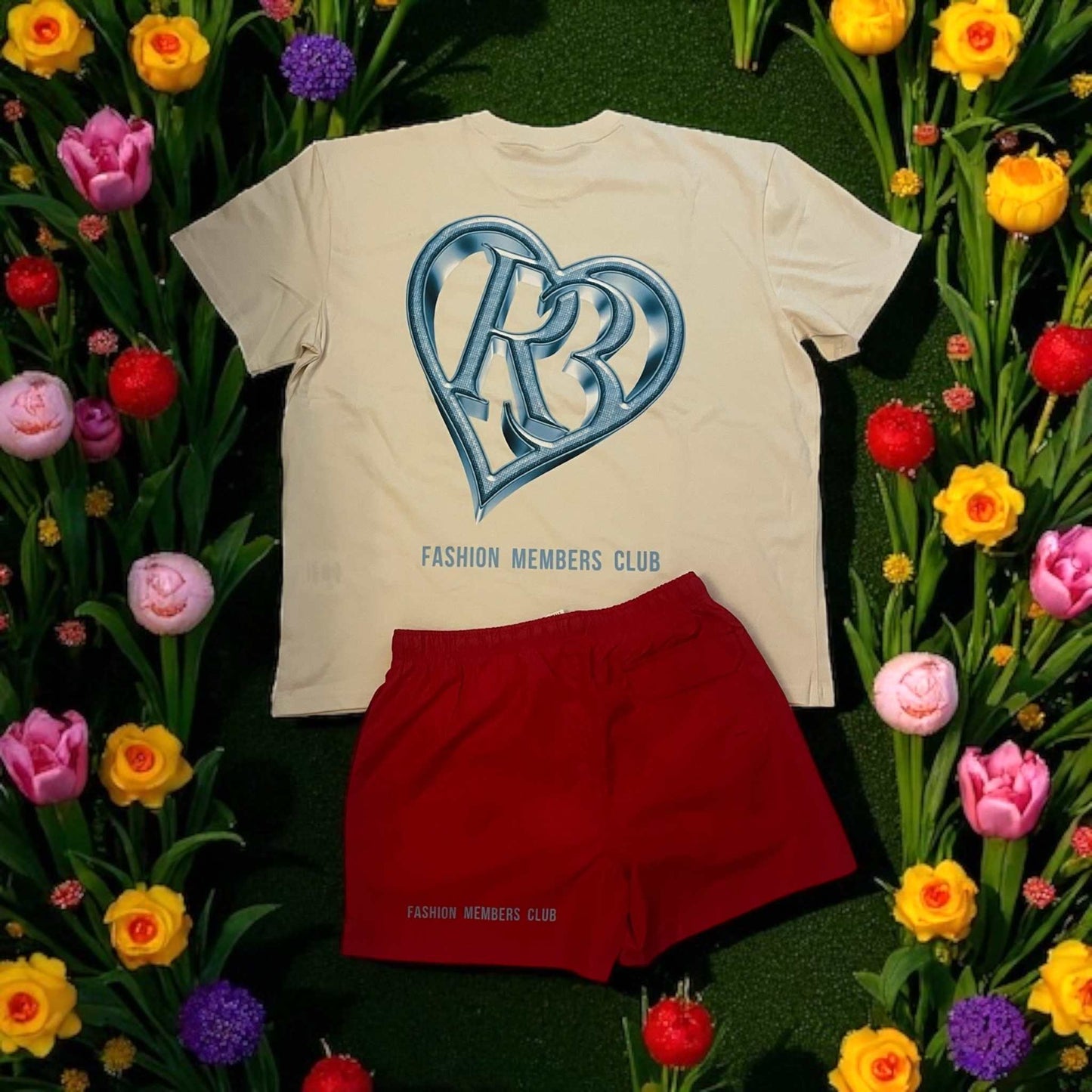men's red swimming trunks with elastic waistband and pockets from R3 Fashion Members Club laid on grass with white T-shirt and colorful flowers around