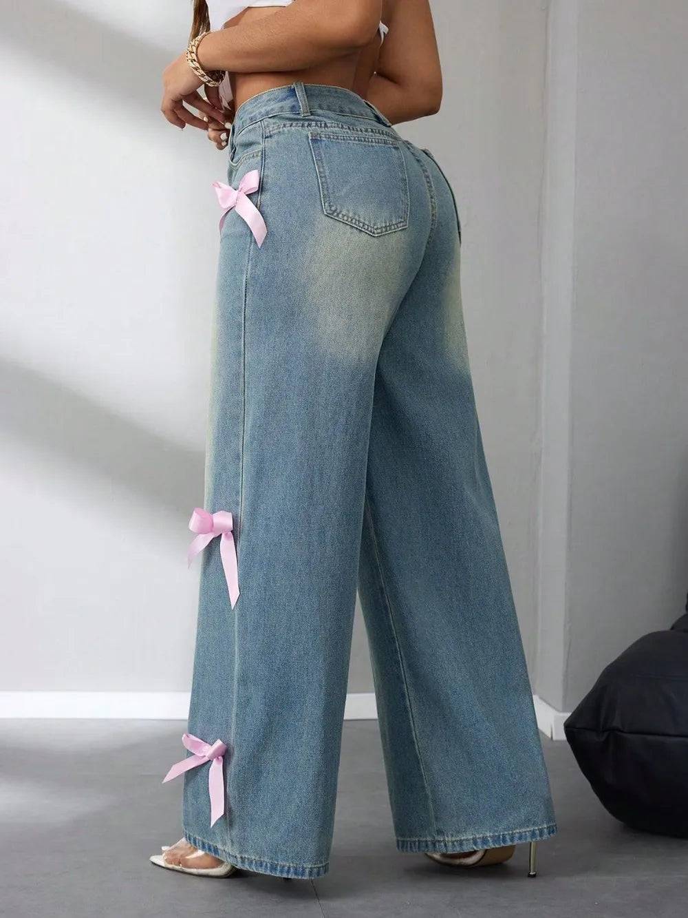 Women wearing Ribbons & Raw denim jeans with pink bow details and a wide-leg fit